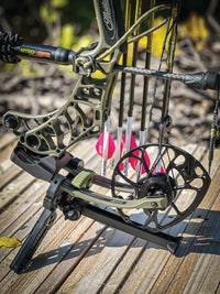 The Pine Ridge Archery Kwik Stand Tri-Pod Bow Support on a Mathews Bow